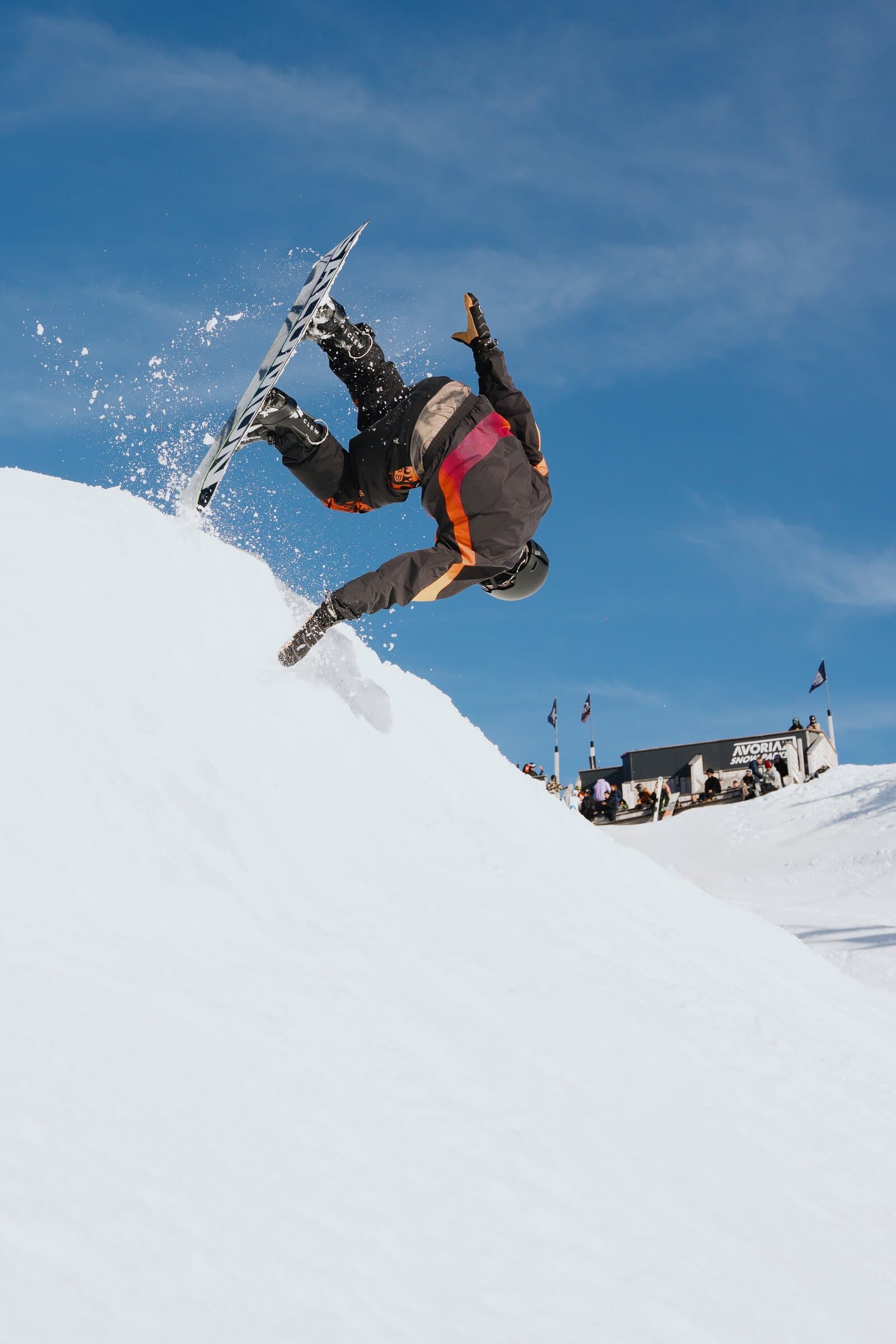 Snowboarder doing backflip with Clew bindings